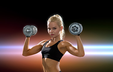 Image showing sporty woman with heavy steel dumbbells