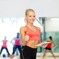 Image showing smiling sporty woman with tablet pc computer