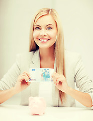 Image showing woman with piggy bank and cash money