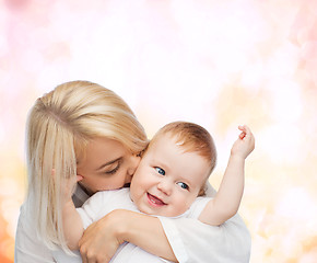 Image showing happy mother kissing smiling baby