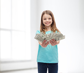 Image showing smiling little girl giving dollar cash money