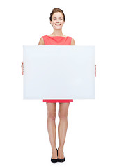 Image showing smiling young woman with blank white board