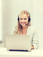 Image showing friendly female helpline operator with laptop