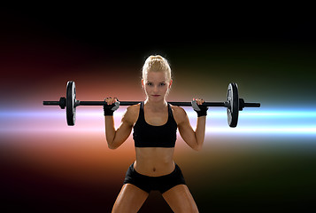 Image showing sporty woman exercising with barbell