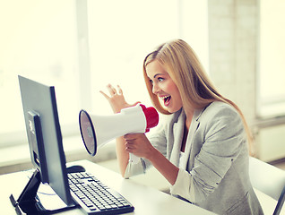 Image showing crazy businesswoman shouting in megaphone