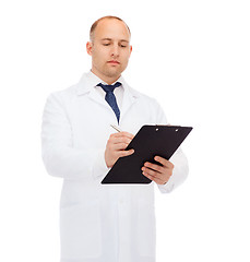 Image showing serious male doctor with clipboard