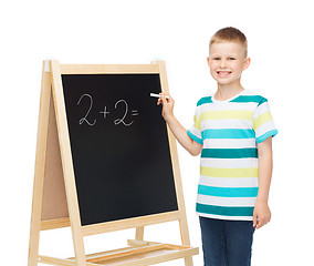 Image showing happy little boy with blackboard and chalk