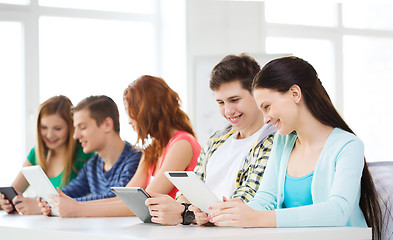 Image showing smiling students with tablet pc at school