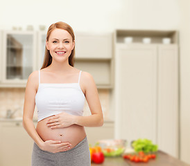 Image showing happy future mother touching her belly