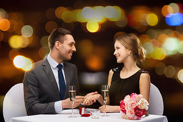 Image showing man proposing to his girlfriend at restaurant