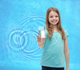 Image showing smiling little girl giving glass of water