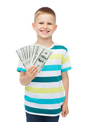 Image showing smiling boy holding dollar cash money in his hand