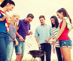 Image showing group of friends making barbecue on the beach