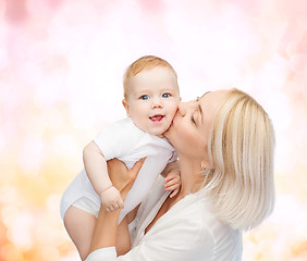 Image showing happy mother kissing smiling baby