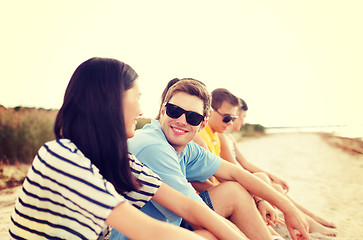 Image showing group of friends or volleyball team on the beach