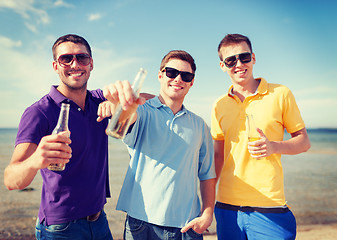 Image showing group of male friends with bottles of beer