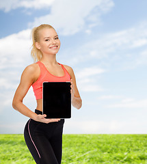 Image showing smiling woman showing tablet pc blank screen