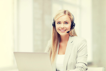 Image showing friendly female helpline operator with laptop