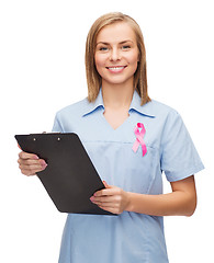 Image showing smiling female doctor or nurse with clipboard