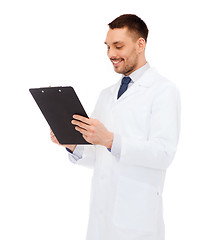 Image showing smiling male doctor with clipboard