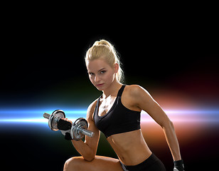 Image showing young sporty woman with heavy steel dumbbell