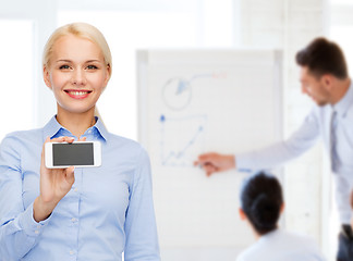 Image showing smiling businesswoman with smartphone blank screen