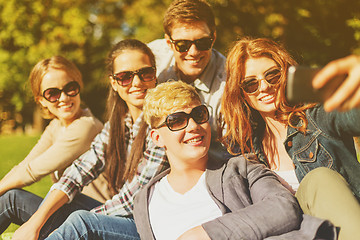 Image showing teenagers taking photo with smartphone outside