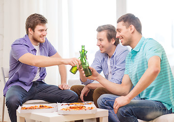 Image showing smiling friends with beer and pizza hanging out