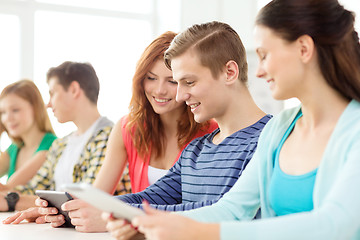 Image showing smiling students with tablet pc at school