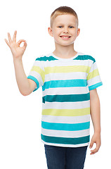 Image showing little boy in casual clothes showing OK gesture