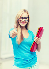 Image showing smiling student with folders