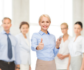 Image showing young smiling businesswoman with smartphone