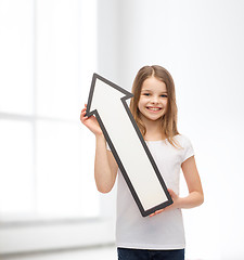 Image showing smiling little girl with blank arrow pointing up