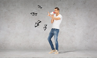 Image showing handsome man with megaphone over concrete wall