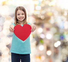 Image showing smiling little girl giving red heart