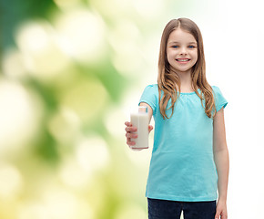 Image showing smiling little girl giving glass of milk