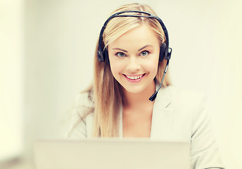 Image showing friendly female helpline operator with laptop