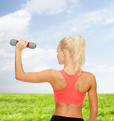 Image showing young sporty woman with light dumbbell