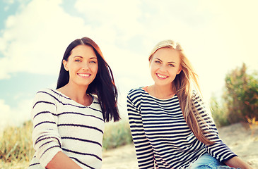 Image showing smiling girlfriends having fun on the beach