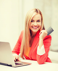 Image showing businesswoman with laptop using credit card