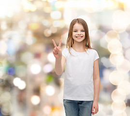 Image showing little girl in white t-shirt showing peace gesture