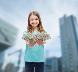 Image showing smiling little girl giving dollar cash money