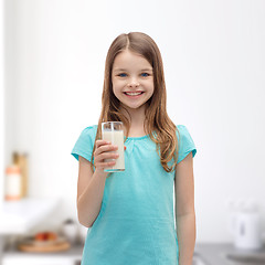 Image showing smiling little girl with glass of milk