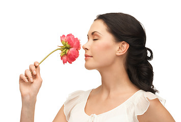 Image showing young and beautiful woman smelling flower