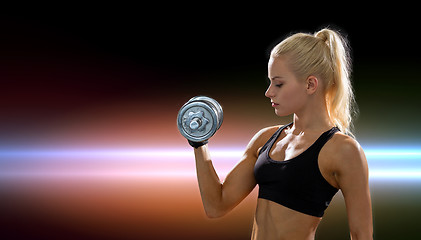 Image showing young sporty woman with heavy steel dumbbell