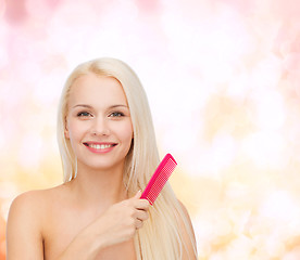 Image showing smiling woman with hair brush