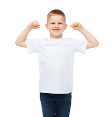 Image showing little boy in blank white t-shirt showing muscles