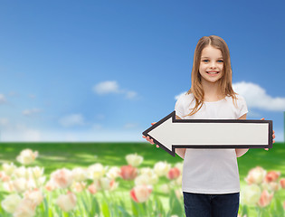 Image showing smiling girl with blank arrow pointing left