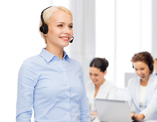 Image showing friendly female helpline operator with headphones