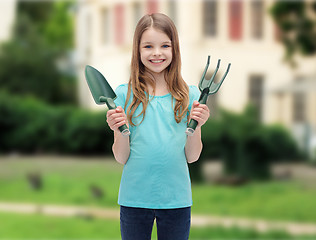 Image showing smiling little girl with rake and scoop